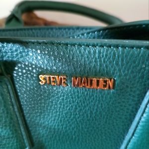 A Steve Madden Pine Green Handbag with Shoulder straps included.